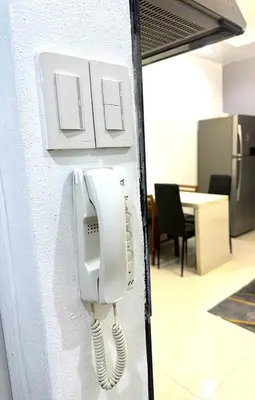 a phone is hanging on a wall in an office at 1 Bedroom Seaview Room Korean Town heart of malate in Manila