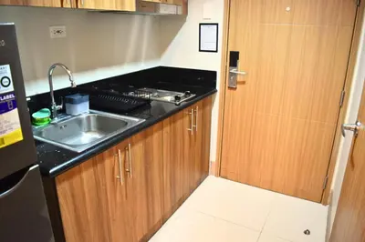 a small kitchen with a sink and a counter top at Shore Staycation at Shore 3 Mall of Asia in Manila