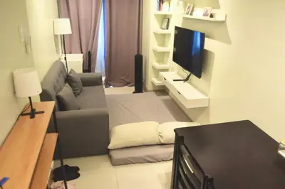 a living room with a couch and a flat screen tv at Shore Staycation at Shore 3 Mall of Asia in Manila