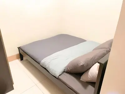a small bed in a room with at Shore Staycation at Shore 3 Mall of Asia in Manila