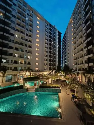a swimming pool in front of two large buildings at The Destination in Manila