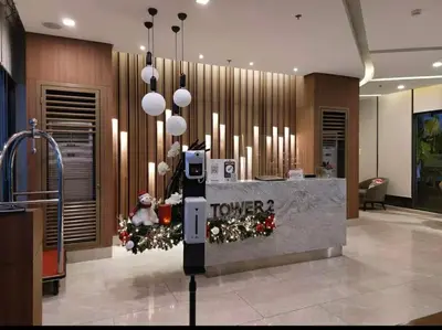 a hotel lobby with a christmas tree and a reception desk at The Destination in Manila