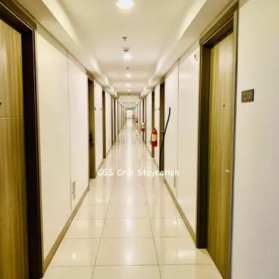 an empty corridor of an office building with a long hallway at CGS Crib staycation in Manila
