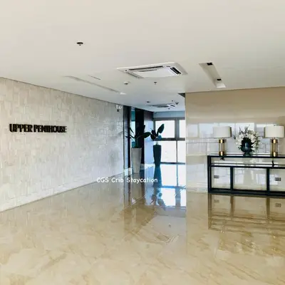 a lobby of a hotel with a reception desk at CGS Crib staycation in Manila