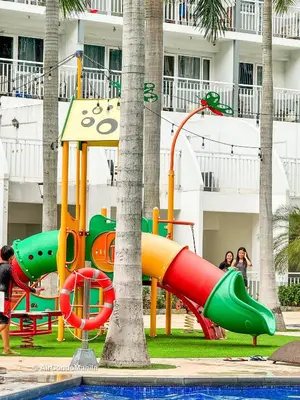 a playground in a resort with a slide at 1442 Air Condo Signature Stay Modern 1BR w Balcony in Manila