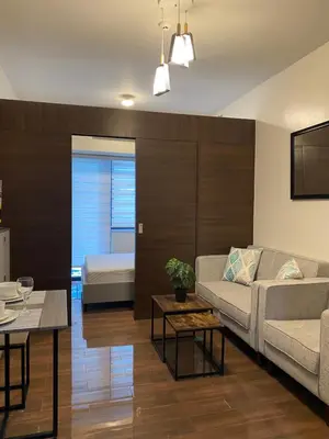 a living room with a couch and a bed at Modern Chic Condo at Makati with WiFi and Netflix in Manila