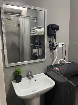 a bathroom with a sink and a mirror at Modern Chic Condo at Makati with WiFi and Netflix in Manila