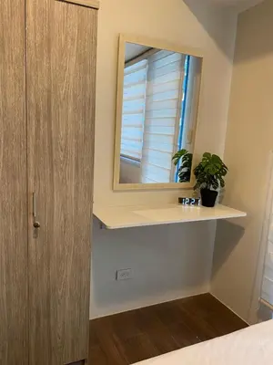 a bathroom with a sink and a mirror at Modern Chic Condo at Makati with WiFi and Netflix in Manila