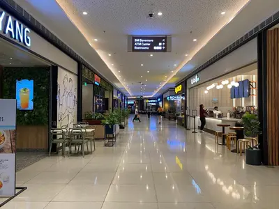 a large shopping mall with tables and chairs in it at Modern Chic Condo at Makati with WiFi and Netflix in Manila