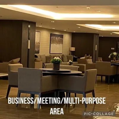 a lobby with a waiting room with a table and chairs at Modern Chic Condo at Makati with WiFi and Netflix in Manila