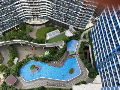 an aerial view of a pool in a city with tall buildings at Modern Chic Condo at Makati with WiFi and Netflix in Manila