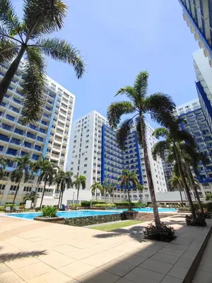 a resort with palm trees and tall buildings at Staycationsite at Sea Residences in Manila