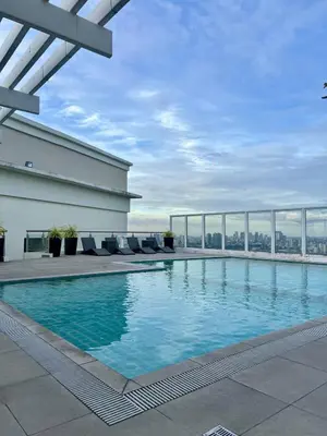 a swimming pool on the roof of a building at High and Cozy in Manila