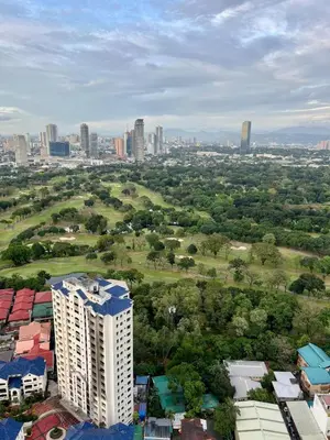 an aerial view of a city with a tall building at High and Cozy in Manila