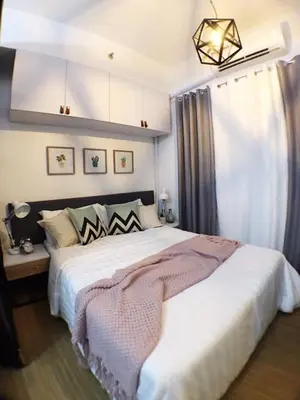 a bedroom with a large bed in a room at Airy condo w balcony, Netflix, 3 pools, sleeps 3 in Manila