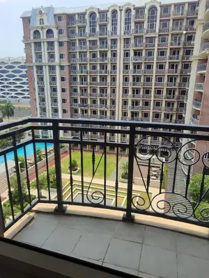 a balcony with a view of a large building at WS906 Condo near Moa, Free Pool Access in Manila