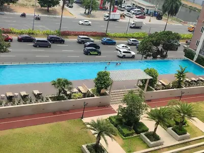 an aerial view of a parking lot with a large pool at WS906 Condo near Moa, Free Pool Access in Manila