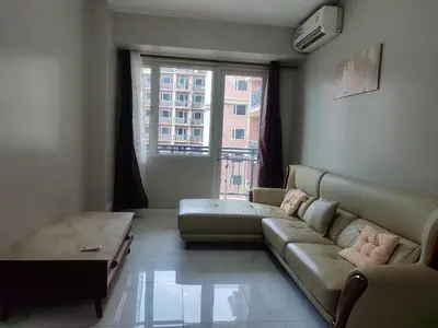 a living room with a couch and a large window at WS906 Condo near Moa, Free Pool Access in Manila