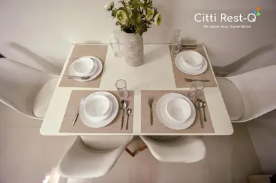 a table with white plates and silverware on it at Stylish Condo with Free Wifi & Netflix, Near Airport HMS3 in Manila