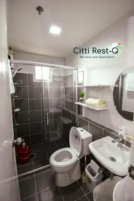 a bathroom with a toilet and a sink at Stylish Condo with Free Wifi & Netflix, Near Airport HMS3 in Manila