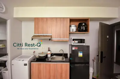 a small kitchen with a sink and a refrigerator at Stylish Condo with Free Wifi & Netflix, Near Airport HMS3 in Manila