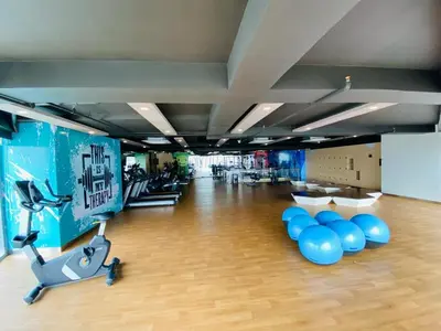 a gym with blue balloons and a exercise bike at Eastwood City 1BR Muji Home Luxe Minimalist Fast WiFi in Manila
