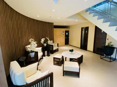 a lobby with couches and a table and chairs at Eastwood City 1BR Muji Home Luxe Minimalist Fast WiFi in Manila
