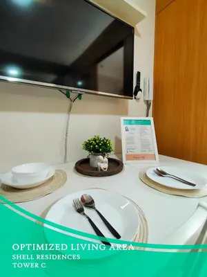 a table with plates and utensils on top of it at GV Holiday Homes - Shell Residences MOA - Cozy 1BR Apartment in Manila