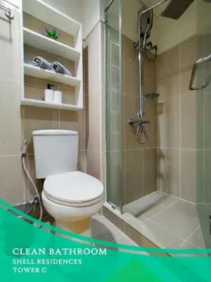 a bathroom with a toilet and a shower at GV Holiday Homes - Shell Residences MOA - Cozy 1BR Apartment in Manila