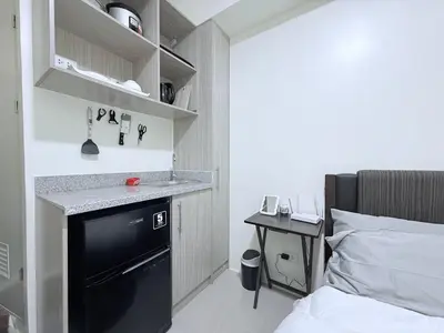 a small bedroom with a sink and a bed at Urban Deca Towers Cubao in Manila
