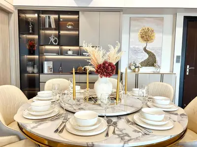 a dining room with a table with plates and silverware at Executive 5BR Penthouse Suite in Uptown BGC in Manila