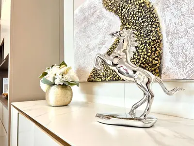 a metal statue of a giraffe sitting on a table at Executive 5BR Penthouse Suite in Uptown BGC in Manila