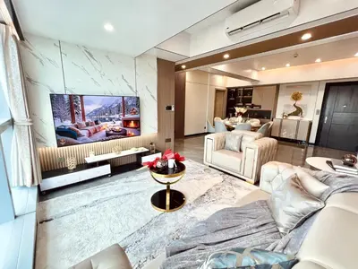 a living room with a couch and a tv at Executive 5BR Penthouse Suite in Uptown BGC in Manila