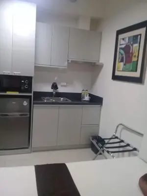 a kitchen with white cabinets and a sink at Studio Unit at The Beacon Makati in Manila