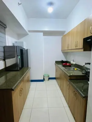 a kitchen with a sink and a microwave at Torre De Manila taft Tan38 in Manila
