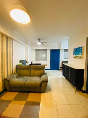 a living room with a couch and a table at Torre De Manila taft Tan38 in Manila
