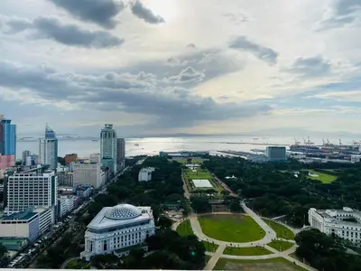 an aerial view of a city with buildings and a park at Torre De Manila taft Tan38 in Manila