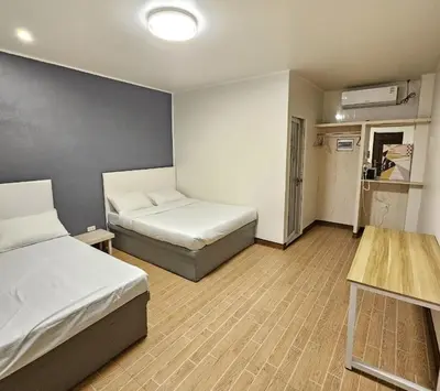 a small room with two beds and a table at The Nice rssort in General Trias