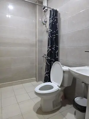 a bathroom with a toilet and a shower and a sink at The Nice rssort in General Trias