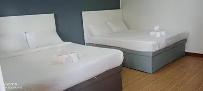 two twin beds in a room with at The Nice rssort in General Trias