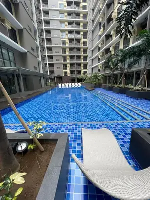 a large swimming pool with blue tiles in a building at 1BR with Queen Bed and Balcony, Walk to Okada in Manila
