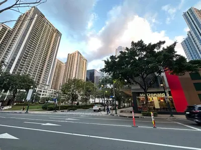 a street in a city with tall buildings at Spacious 1BR Condo with 300mbps WiFi in BGC in Manila