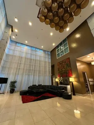 a living room with a couch and a large window at Spacious 1BR Condo with 300mbps WiFi in BGC in Manila