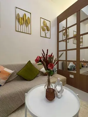 a living room with a vase of flowers on a table at Casa Aotea in Sampong