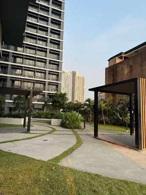 a pavilion in a park in front of a tall building at Casa Aotea in Sampong