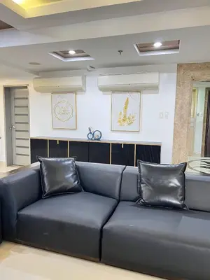 a large blue couch in a living room at R&R Empire Rental Unit in Manila