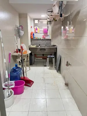 a kitchen with a sink and a tiled floor at R&R Empire Rental Unit in Manila