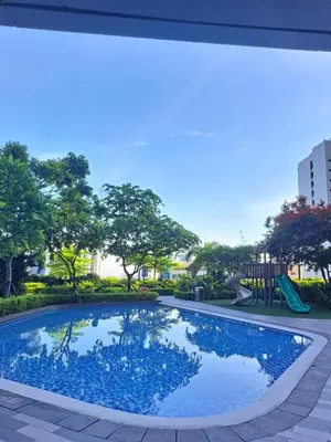 a swimming pool in a park with a playground at Air Residences in Manila