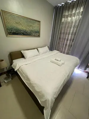 a bed with a towel on it in a bedroom at Makati City Antel Spa Residences 2306 in Manila
