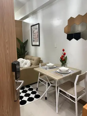 a living room with a table and a couch at Modern japan home in the Philippines in Manila